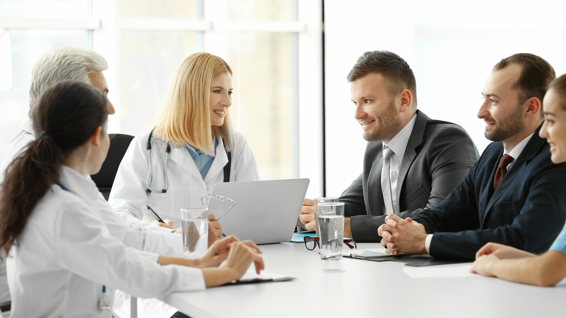 Generic stock photo of doctor with people dressed in suits.