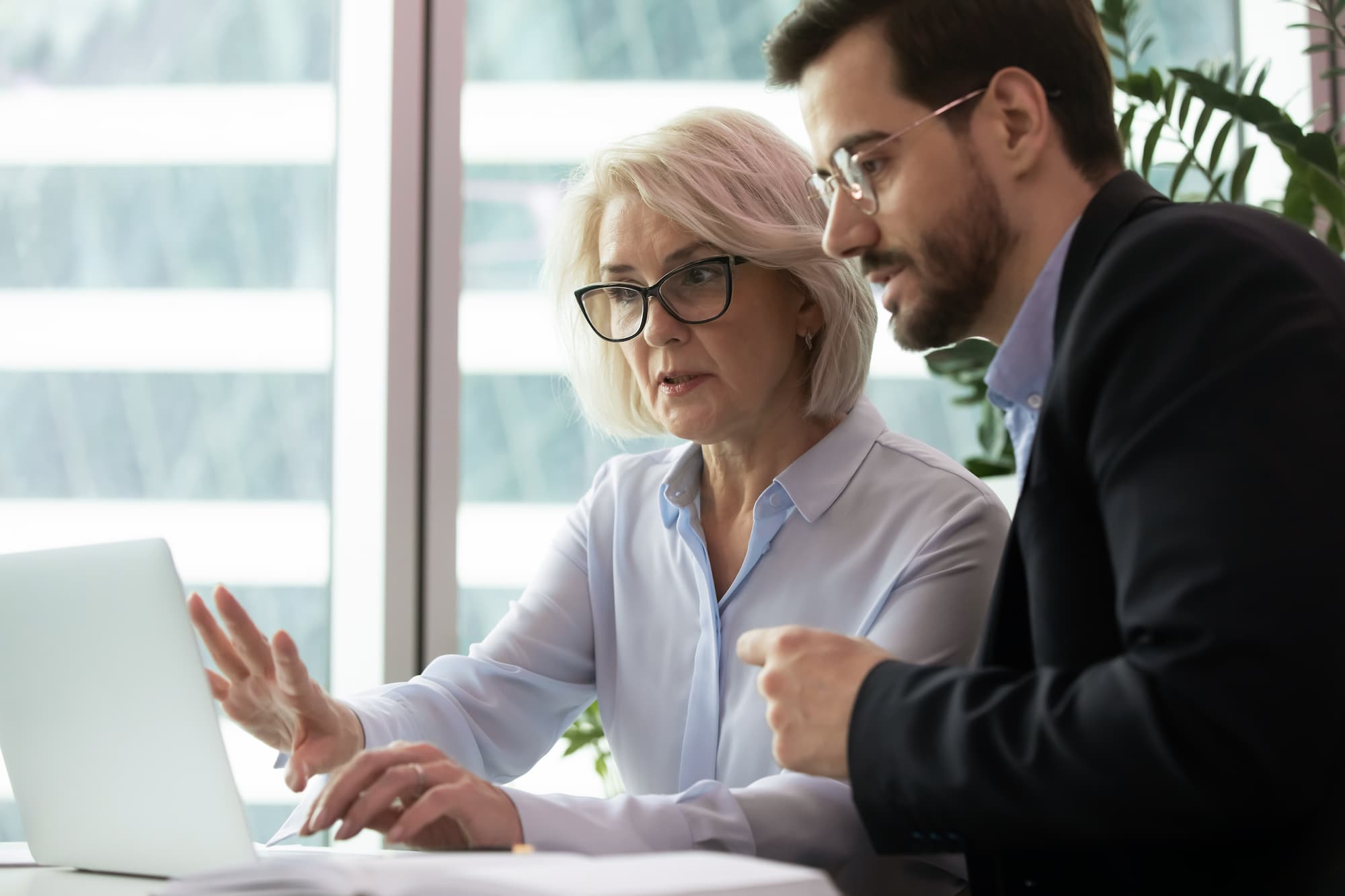 Stock photo of two people examining doctor records.