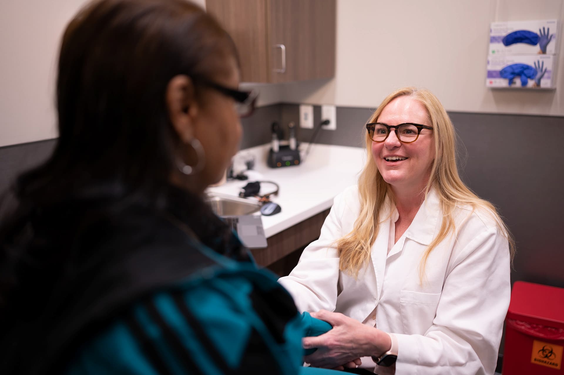 A physician with a patient in exam room