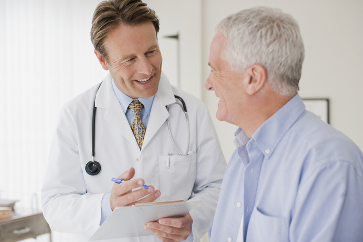 Doctor talking with patient in doctors office