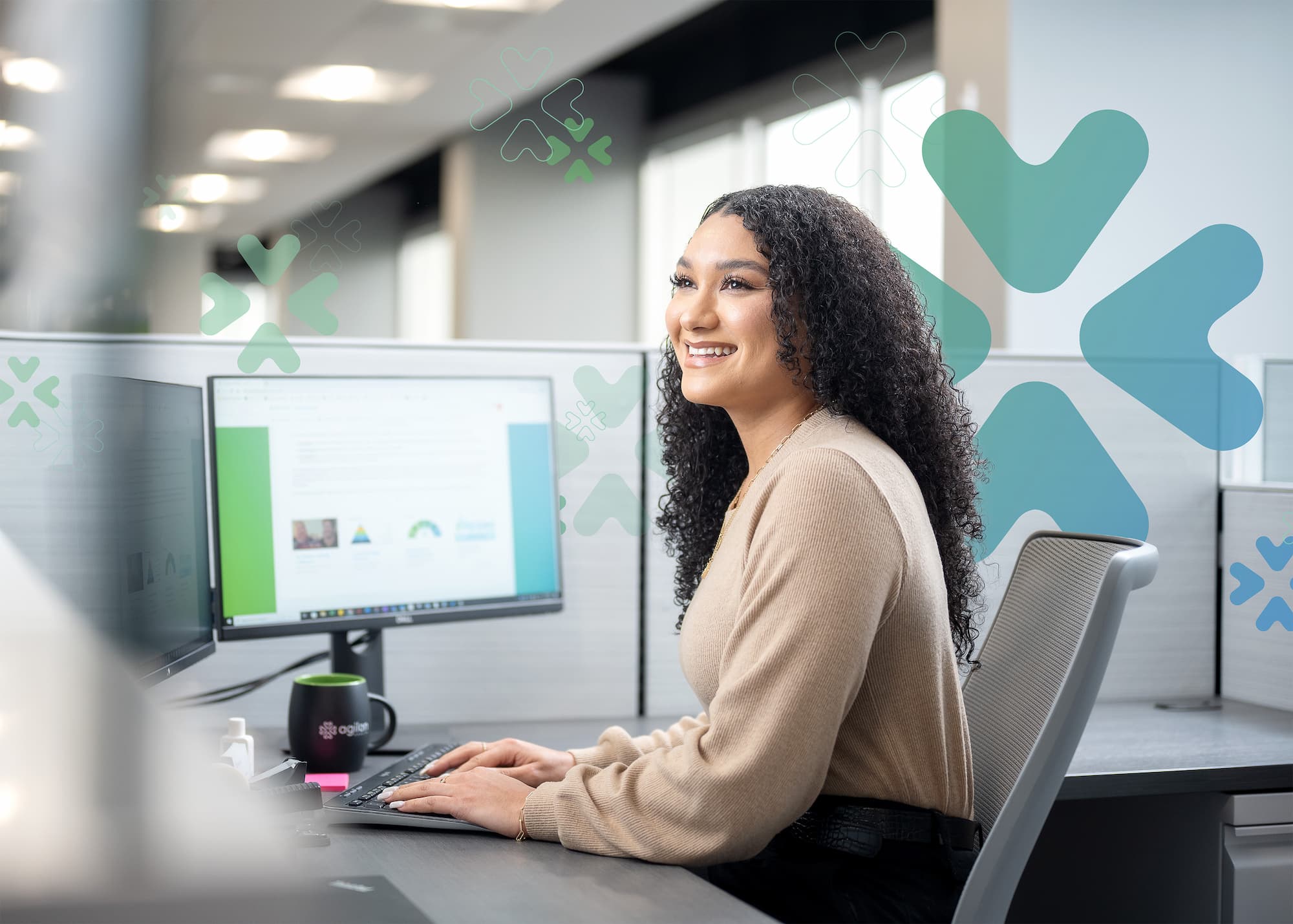 An agilon employee sitting at her desk.