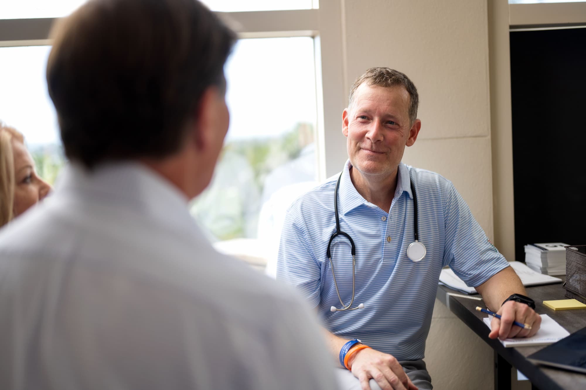 Generic photo of a doctor speaking with a patient.