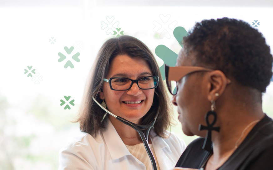 Generic stock photo of a doctor with a patient with agilon related branding on it.